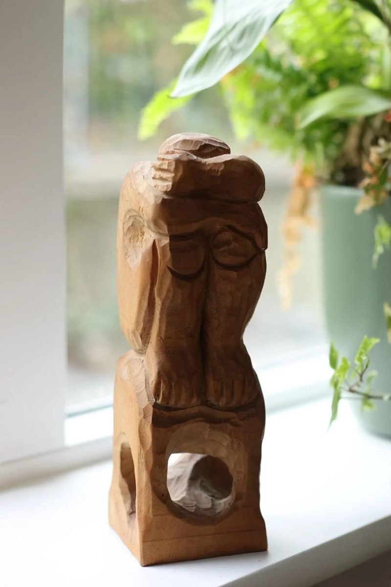 Carved wooden figure on a windowsill